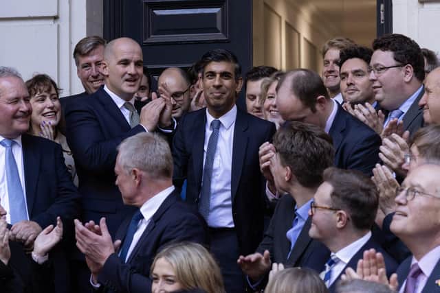 Conservative party leader Rishi Sunak arrives at CCHQ after being elected party leader, and is applauded by Party Chairman, Jake Berry