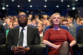 BIRMINGHAM, ENGLAND - OCTOBER 02: Chancellor of the Exchequer Kwasi Kwarteng and British Prime Minister Liz Truss attend the annual Conservative Party conference on October 02, 2022 in Birmingham, England. This year the Conservative Party Conference will be looking at "Getting Britain Moving" with more jobs and higher salaries. However, delegates are arriving at the conference as the party lags 33 points behind Labour in the opinion polls. (Photo by Leon Neal/Getty Images)