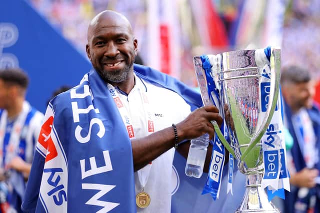 MAGIC MOMENT: Sheffield Wednesday boss Darren Moore celebrates with the trophy after his team's victory against Barnsley sealed promotion to the Championship at Wembley Stadium on Monday, Picture: Richard Heathcote/Getty Images.