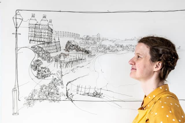 Wire artist Helaina Sharpley, in front of artwork copied from a photograph of Scarborough in 1887