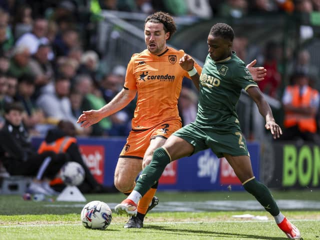 Plymouth Argyle's Bali Mumba and Hull City's Lewis Coyle in action during the Sky Bet Championship match at Home Park. Photo: Steven Paston/PA Wire.