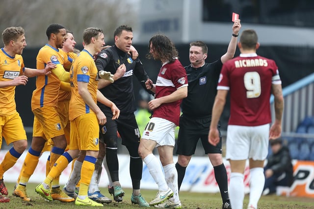 John-Joe O'Toole of Northampton Town is shown a red card by referee Lee Collins during the Sky Bet League Two match between Mansfield Town and Northampton Town at One Call Stadium on February 14, 2015.