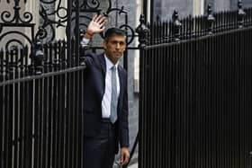 Rishi Sunak poses after taking office outside Number 10