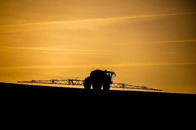 A farmer sprays crops in a field. PIC: James Hardisty
