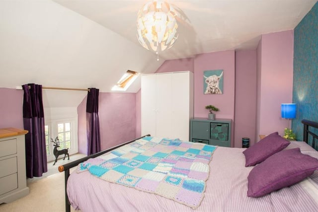 This pretty pink bedroom has lovely views
