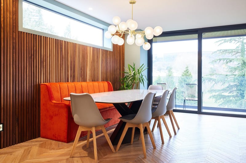 This breakfast/ dining area includes an orange banquette adding colour, comfort and style