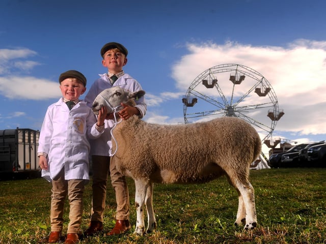 Oliver, aged four, and Thomas Smith, aged eight, from Dunford Bridge, with their mule called Hilda