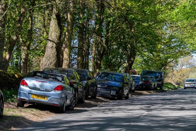 Visitors parking on the roadside outside Leeds' Golden Acre park. Image: James Hardisty