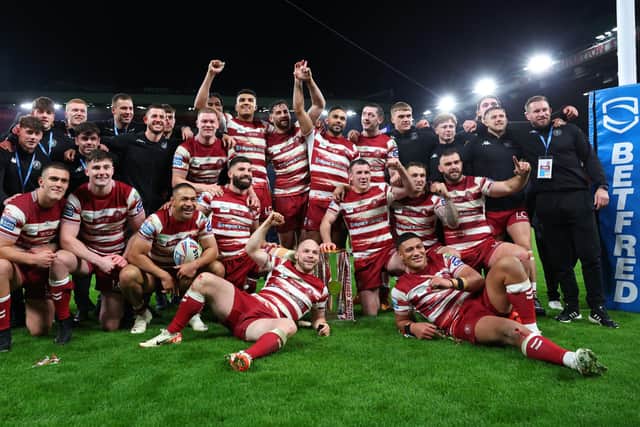 Wigan players and staff celebrate with the Super League trophy. (Photo by Alex Livesey/Getty Images)