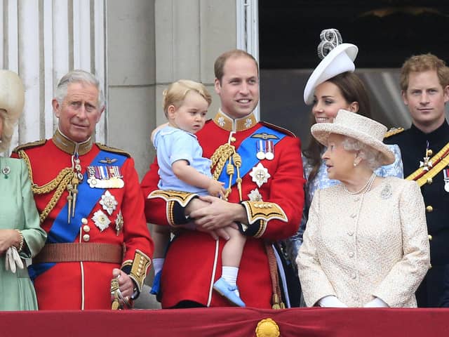 The Queen looks at her three heirs - Prince Charles, Prince William and Prince George - in 2015