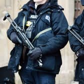 Metropolitan Police firearms officers stand outside the Houses of Parliament in London. PIC: PA
