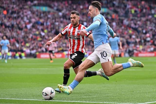 DUEL: Sheffield United's George Baldock put his friendship with Manchester City's Jack Grealish (right) on hold at Wembley