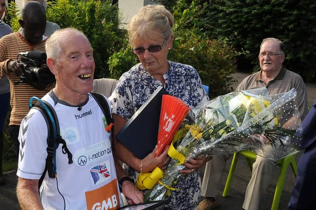Ray Matthews with his wife Maureen after he has finished his 75th marathon at Newman School. Picture: Andrew Roe