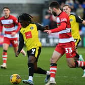 Harrogate Town's Abraham Odoh takes on Doncaster Rovers' Ben Close in the League Two game last month. Picture: Jonathan Gawthorpe