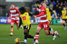 Harrogate Town's Abraham Odoh takes on Doncaster Rovers' Ben Close in the League Two game last month. Picture: Jonathan Gawthorpe