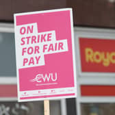 A a sign held by a postal worker from the Communication Workers Union (CWU) on the picket line at the Royal Mail Whitechapel Delivery Office in east London. Picture: James Manning.