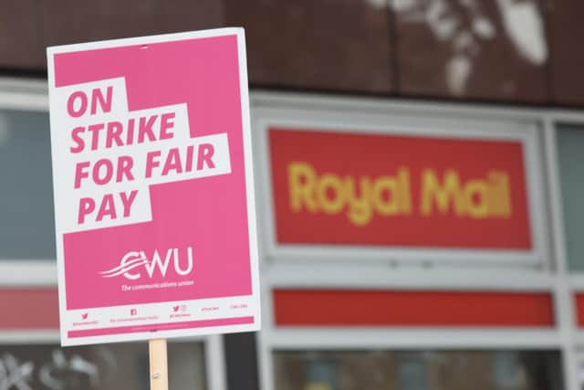 A a sign held by a postal worker from the Communication Workers Union (CWU) on the picket line at the Royal Mail Whitechapel Delivery Office in east London. Picture: James Manning.