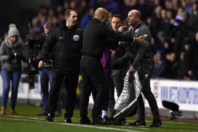GREAT NIGHT: Leam Richardson (second right) watches on as Wigan Athletic manager Paul Cook and Manchester City counterpart Pep Guardiola exchange views during the FA Cup clash between the two back in February 2018 which Wigan won 1-0. Picture: Gareth Copley/Getty Images.