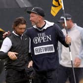 Tommy Fleetwood of England speaks with their caddy on the 18th green on Day Four of The 151st Open at Royal Liverpool after coming up short (Picture: Gregory Shamus/Getty Images)