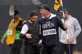 Tommy Fleetwood of England speaks with their caddy on the 18th green on Day Four of The 151st Open at Royal Liverpool after coming up short (Picture: Gregory Shamus/Getty Images)