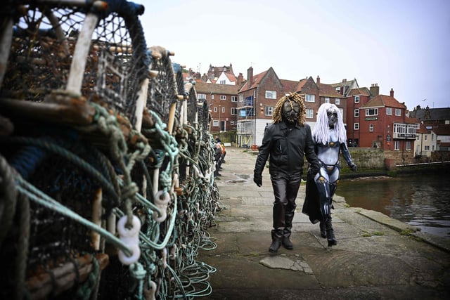 Two goths take a stroll by the sea during Whitby Goth Weekend