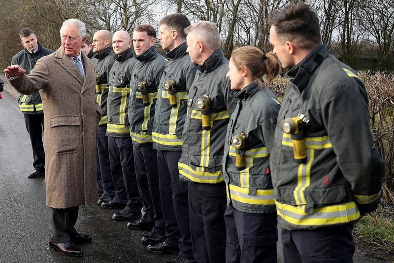 The Prince of Wales meets emergency service personnel during a visit to Fishlake, in South Yorkshire, which was hit by floods in December 2019.