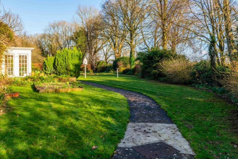 The house is set in 3.7 acres of gardens and paddocks