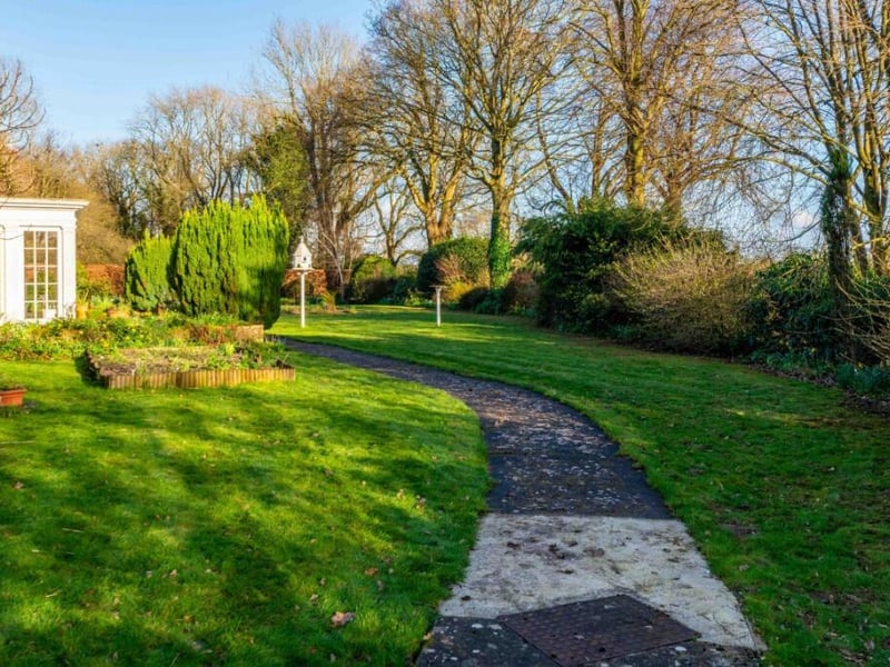 The house is set in 3.7 acres of gardens and paddocks
