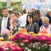 Members of the public look at displays on show at the 2021 RHS Chelsea Flower Show in London. Photo by JUSTIN TALLIS/AFP via Getty Images.