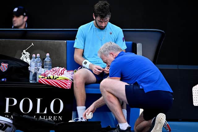 Britain's Cameron Norrie gets medical attention as he competes against Czech Republic's Jiri Lehecka during their men's singles match on day five of the Australian Open (Picture: ANTHONY WALLACE/AFP via Getty Images)