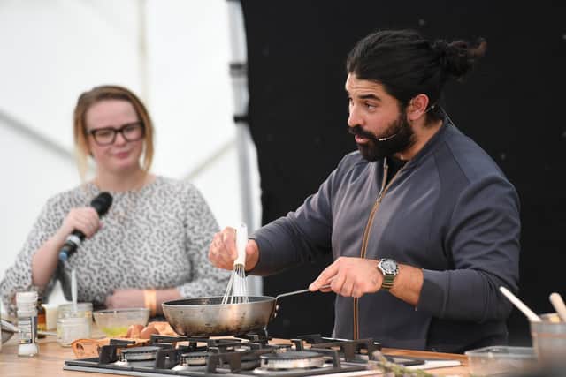 MasterChef 2022 winner Eddie Scott (right) during his cooking demonstration at the Live Cookery Theatre at Harrogate Food and Drink Festival 2022
