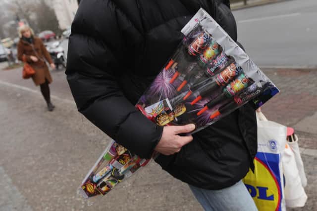 A man carries a package of fireworks he purchased at a supermarket on December 29, 2009 in Berlin, Germany.  (Photo by Sean Gallup/Getty Images)
