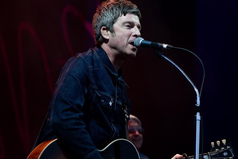 Noel Gallagher played his guitar and sang to a crowd of fans.