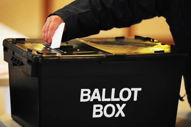 A voter placing a ballot paper in the ballot box. PIC: PA