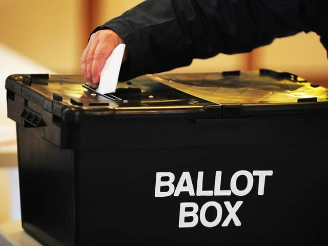 A voter placing a ballot paper in the ballot box. PIC: PA
