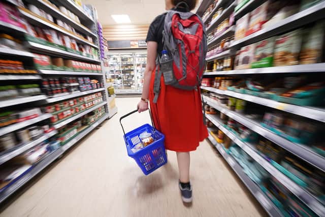 A shopper walking through the aisle of a Tesco supermarket in London. Picture date: Saturday September 3, 2022.