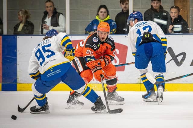 LOCAL RIVALS: Sheffield Steeldogs' Jonathan Phillips battles with Leeds Knights' Mac Howlett at Elland Road last month. Picture: Knights Media/Ben Gordon