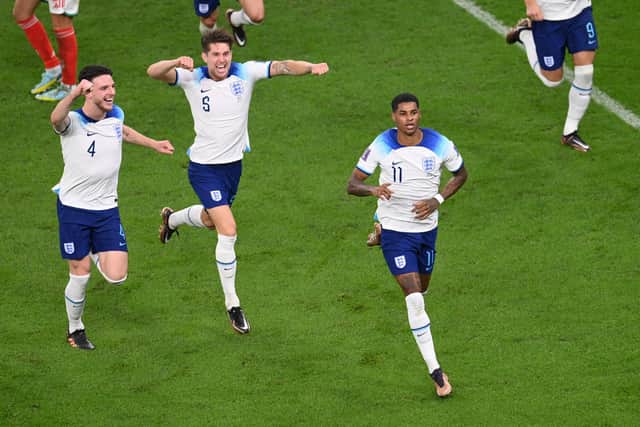 DOHA, QATAR - NOVEMBER 29: Marcus Rashford of England celebrates after scoring their team's first goal during the FIFA World Cup Qatar 2022 Group B match between Wales and England at Ahmad Bin Ali Stadium on November 29, 2022 in Doha, Qatar. (Photo by Stu Forster/Getty Images)