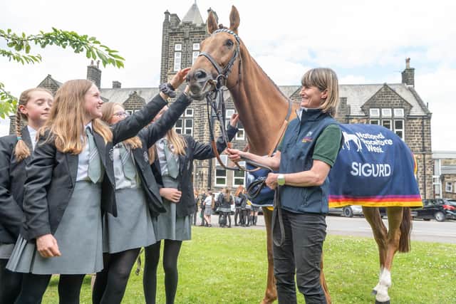 Racehorse Sigurd and trainer Jo Foster (right) meets children aged 11 to 14 from Ilkley Grammar School in Ilkley ahead of National Racehorse Week last year. National Racehorse Week is a celebration of racehorses and the people that care for them, with events taking place at venues across Great Britain from Saturday September 9 until Sunday 17 September. Photo credit should read: Richard Walker/PA Wire