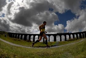 The Three Peaks Race. Runners are pictured running by Ribblehead Viaduct.Picture taken by Yorkshire Post Photographer Simon Hulme