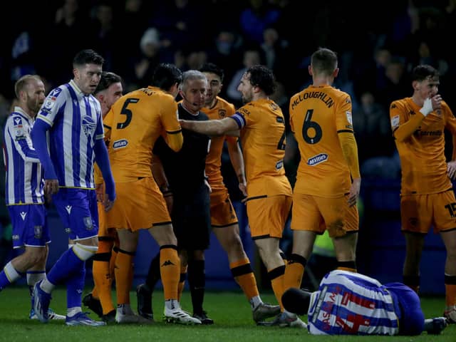 Flashpoint: Hull City's players protest to referee Josh Smith after he showed a red card to Tyler Morton (right) for his foul on Sheffield Wednesday's Djeidi Gassama.