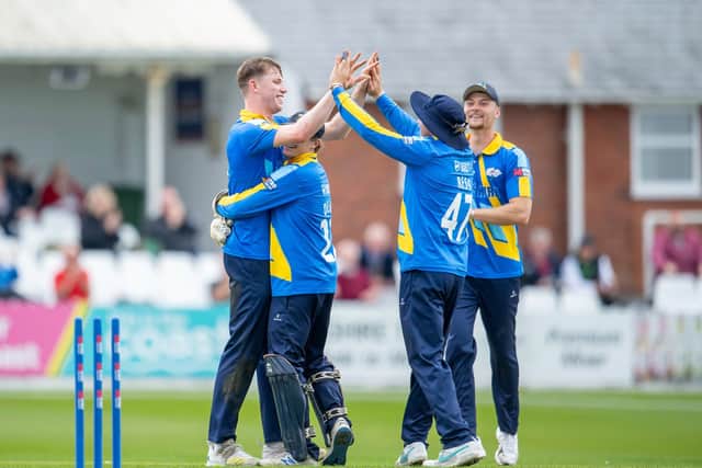 Matthew Revis, left, gets a big hug from wicketkeeper Harry Duke and a high-five from Dom Bess after taking a hat-trick against Kent at Scarborough. Picture by Allan McKenzie/SWpix.com
