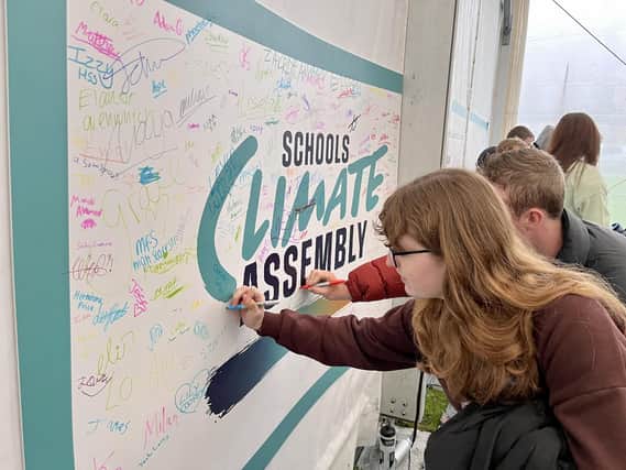 Pupils signing Climate board