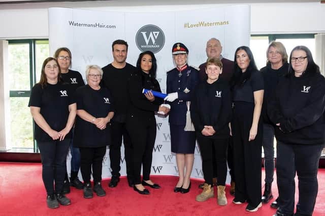 Gail and Matt (centre) along with the Watermans team receiving The Queen Award. (Pic credit: Gail Waterman)