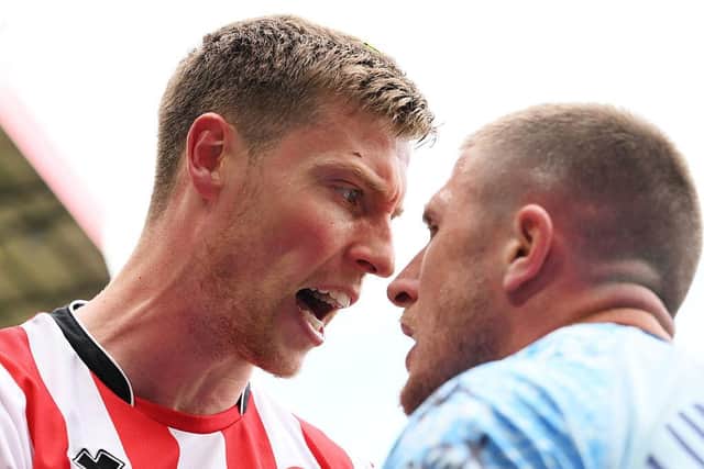 BOOKED: John Lundstram (right) squares up to Mark McGuinness for hsi first booking (Image: Mark Sutton/Getty Images)