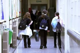 Children walking down the corridor of a school.
