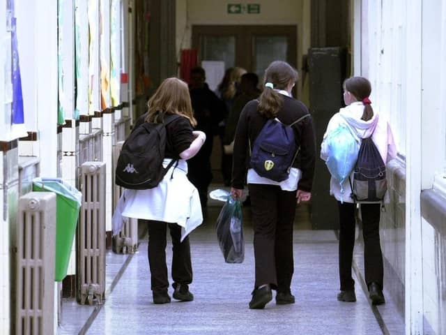 Children walking down the corridor of a school.