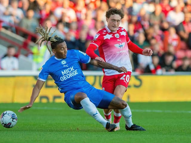 Barnsley's Callum Styles is challenged by Peterborough United rival Romoney Crichlow in the League One fixture at Oakwell in August. Picture: Bruce Rollinson.