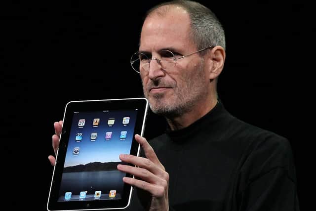 Steve Jobs holds up a new iPad as he speaks during an Apple Special Event at Yerba Buena Center for the Arts January 27, 2010 in San Francisco, California. (Photo by Justin Sullivan/Getty Images)