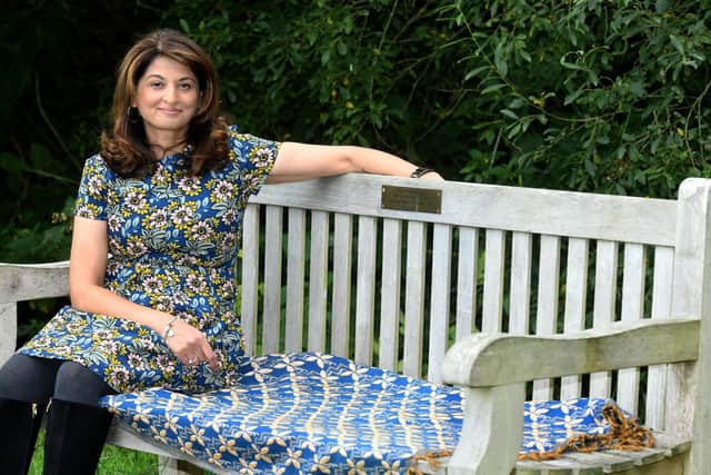 Daxa Patel sat on her father's memorial bench in Golden Acre park in Leeds.